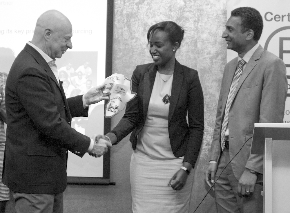 BEST FOR THE WORLD. Caroline Wanjiku, CEO of Daproim Africa, accepts the Best for the World award from Global B Corp ambassador Marcello Palazzi at a B Corp event in Kenya.